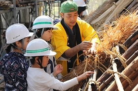 茅を縄でくくり屋根に取り付けます